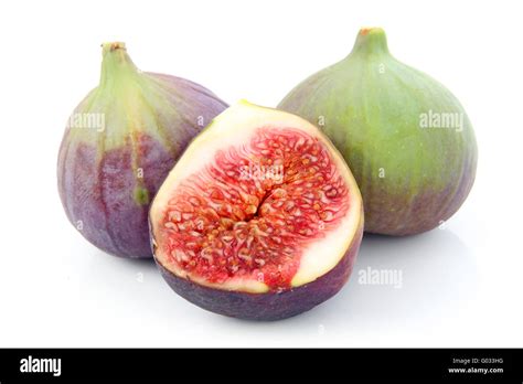 Ripe sliced purple and green fig fruit isolated Stock Photo - Alamy