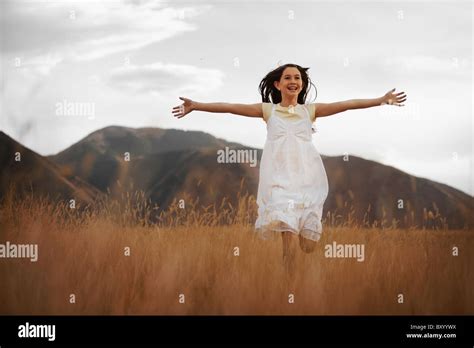 Girl Running Through Wheat Field Stock Photo Alamy