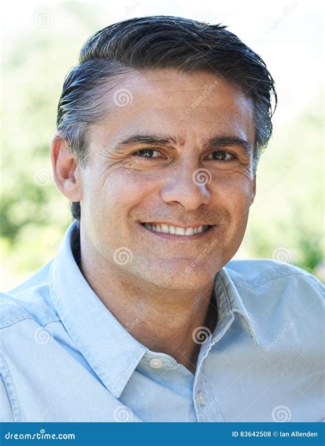Outdoor Head And Shoulders Portrait Of Smiling Mature Man Stock Photo