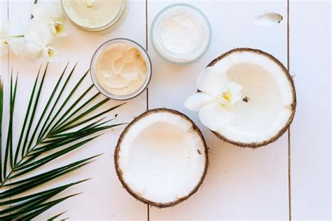 Premium Photo Coconut Oil And Cosmetics With Palm Leaves On White