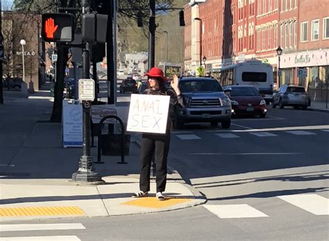 Woman On The Street Waving To Cars With A Sign That Says Anal Sex R Trashy