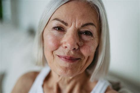 Portrait Of Beautiful Mature Woman With Gray Hair And Soft Smile Stock