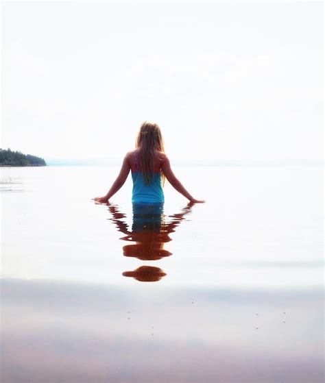 Premium Photo Rear View Of Girl Standing In Lake Against Clear Sky