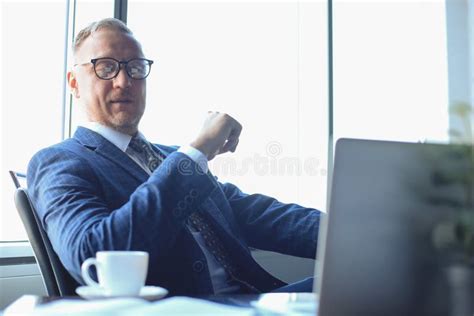 Elegant Mature Businessman Analyzing Data While Working In Office Stock