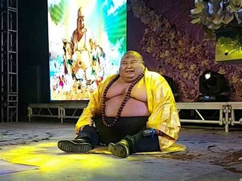 Chinese Man Makes A Living Posing As Real Life Laughing Buddha