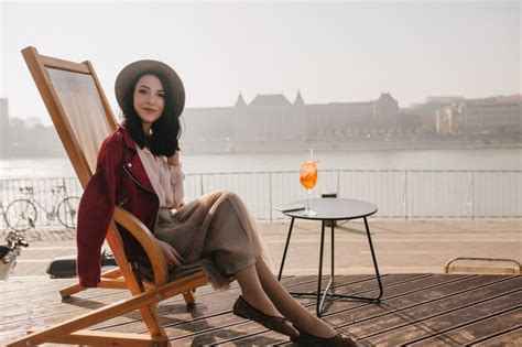 Free Photo Ecstatic Brunette Woman Posing With Pleasure In Chaise Longue