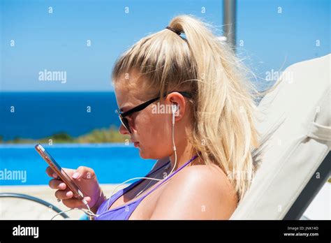 A Girl In A Bikini On Her Mobile Phone On Holiday Making The Most Of The Reduced Mobile Roaming