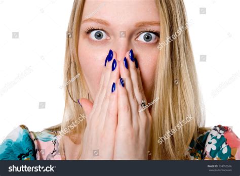 Closeup Of Surprised Young Woman Covering Mouth With Hand Isolated On White Background Stock