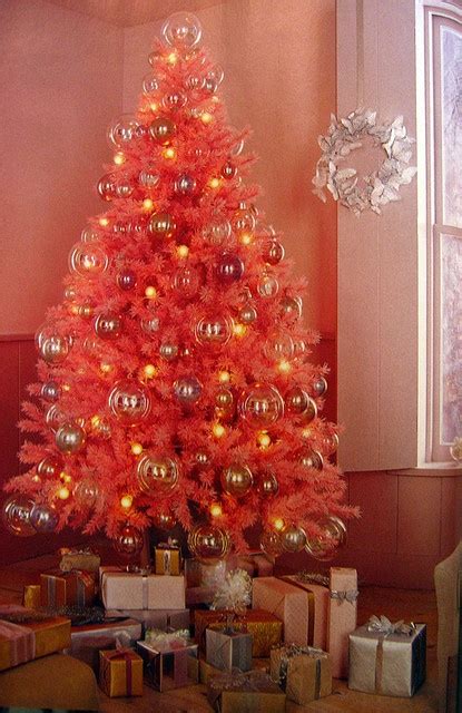 A Bright Red Christmas Tree With Shiny Ornaments