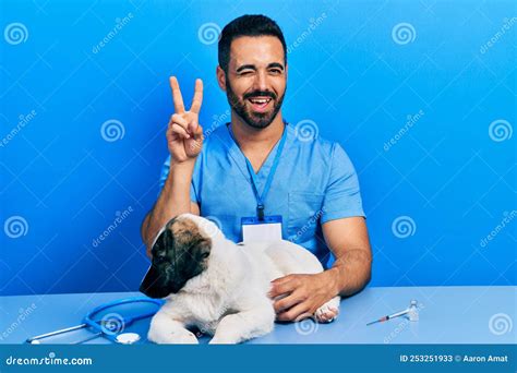 Handsome Hispanic Veterinary Man With Beard Checking Dog Health Smiling