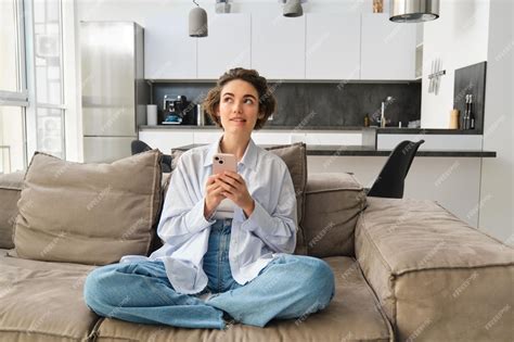 Premium Photo Portrait Of Smiling Woman Chats On Smartphone App Sits