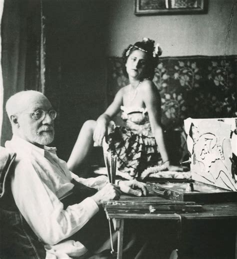 an old man sitting next to a woman on a couch in front of a table