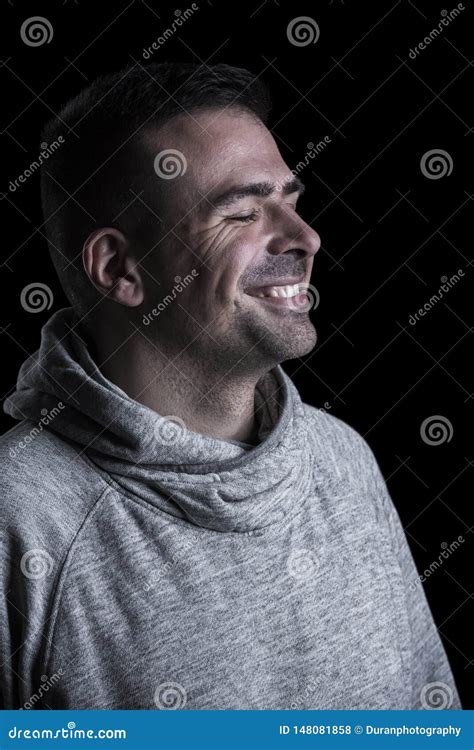 Side Portrait Of A Smiling Man With Closed Eyes Black Background