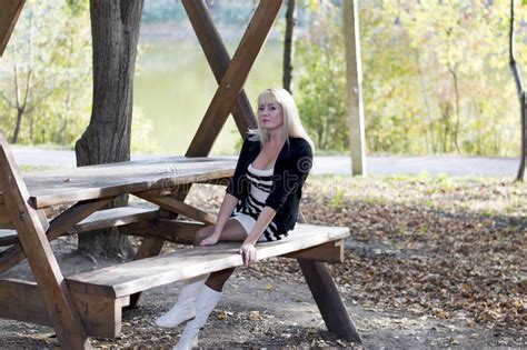 The Blonde Has A Rest On A Bench At A Table In A Park Zone Stock Image Image Of Orange Park