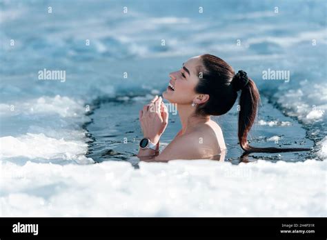 Girl With Bikini And A Watch In Frozen Lake Ice Hole Woman Hardening The Body In Cold Water