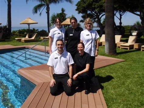 Some People Are Posing For A Picture By The Pool