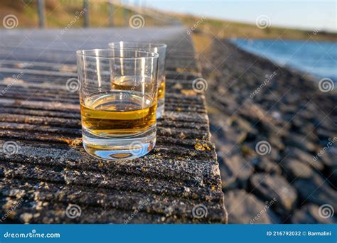 Drinking Single Malt Scotch Whisky At Sunset With Sea Ocean Or River