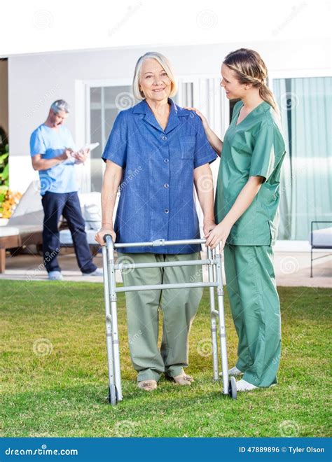 Nurse Helping Senior Woman To Use Walking Frame In Stock Photo Image