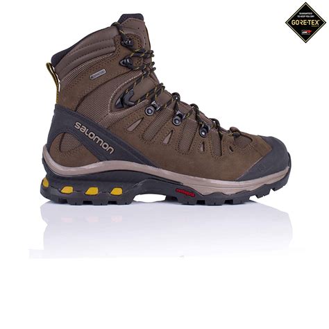 a brown hiking boot with yellow accents on the side and black outstep,