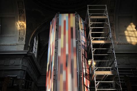 A Ladder Is Attached To The Side Of A Tall Building With Colorful