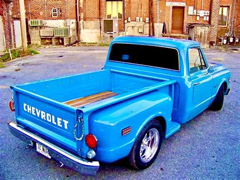 An Old Blue Chevrolet Pickup Truck Parked In A Parking Lot