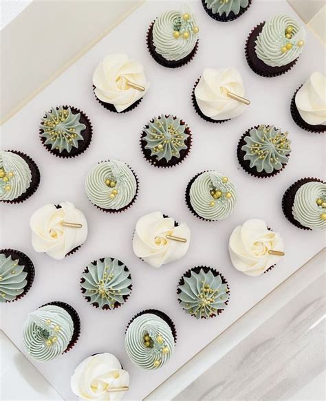 Cupcakes With White Frosting And Green Decorations