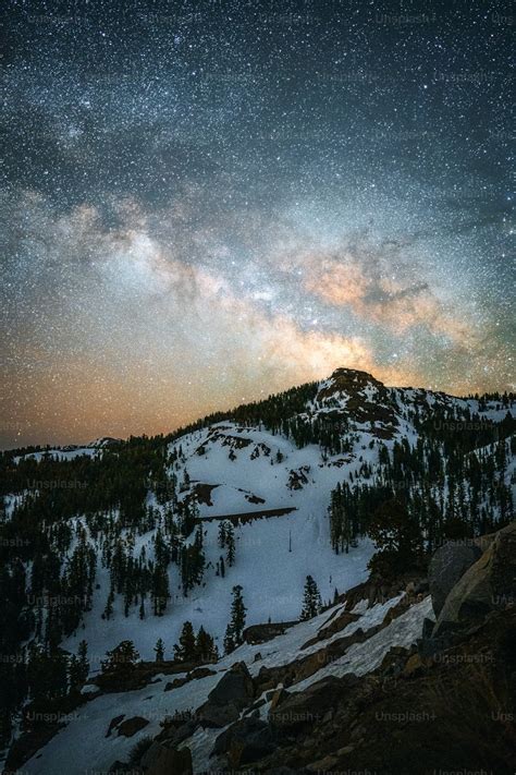 A mountain covered in snow under a night sky photo – California Image ...