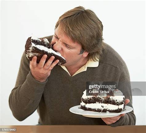 Fat Man Eating Cake Photos And Premium High Res Pictures Getty Images