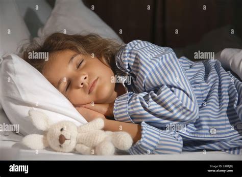 Cute Little Girl Sleeping In Bed At Night Stock Photo Alamy