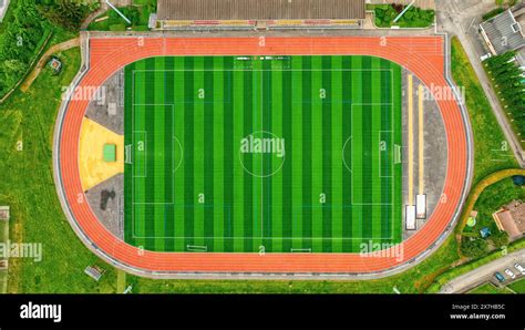 Aerial View Of A Stadium With Running Tracks Green Fields For Football