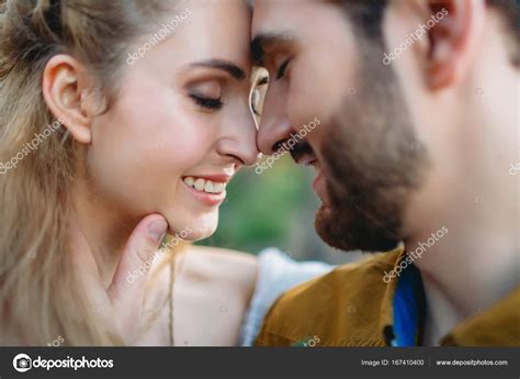 A Young Couple Smile And Touching Foreheads With Closes Eyes Autumn