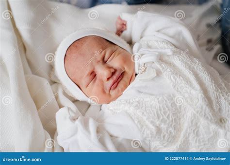 Crying Newborn Baby Sleeps In White Clothes Attire For Discharge From