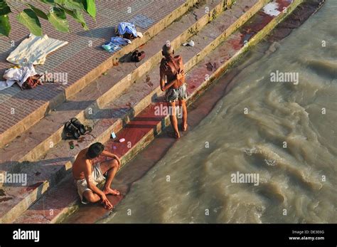 Pilgrims bathing at the ghat by the Ganges river Stock Photo - Alamy