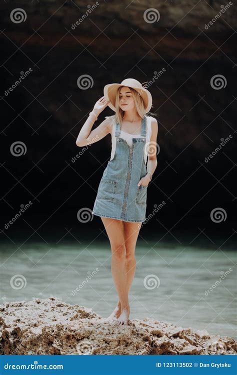 Young Pretty Blonde Woman In Casual Wear And Straw Hat Exploring The