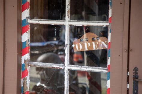 Premium Photo Weathered Barber Shop Open Sign Text On Old Wooden Door