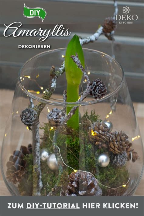 A Glass Vase Filled With Pine Cones And Other Decorations