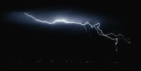 A Lightning Bolt Is Seen In The Dark Sky