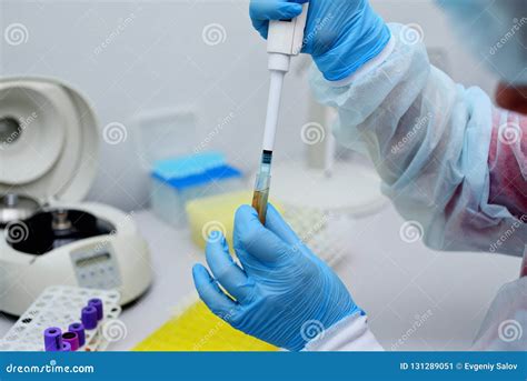 Dna Test In The Lab A Lab Technician Dripping Blood Into A Test Tube