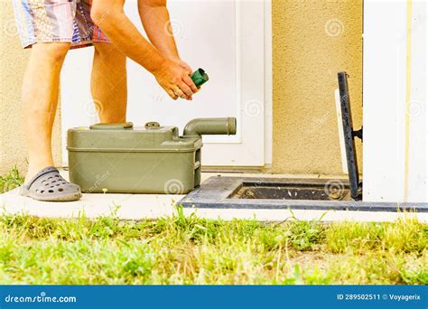 Man Emptying Caravan Tank Toilet Cassette In Dump Station Stock Image