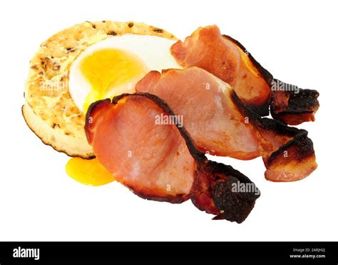 Fried Egg And Smoked Bacon Rashers On A Large English Crumpet Isolated