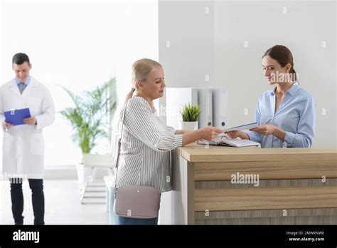 Patient Taking Her Medical Record Before Doctors Appointment In