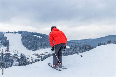 Лыжник. Лыжник готовиться спуститься с горы фотография Stock | Adobe Stock