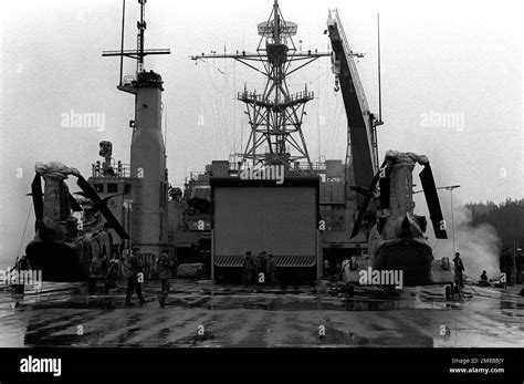 Navy And Marine Personnel Stand On The Flight Deck Of The Dock Landing