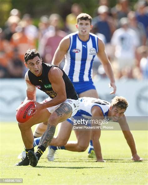 Tim Taranto of the Tigers looks to pass the ball during the AFL Match ...