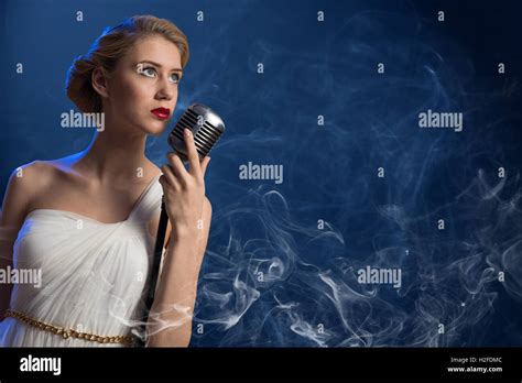 attractive female singer with microphone Stock Photo - Alamy