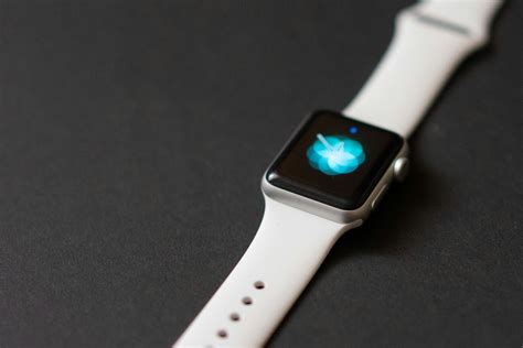 A White Smartwatch On Black Surface · Free Stock Photo