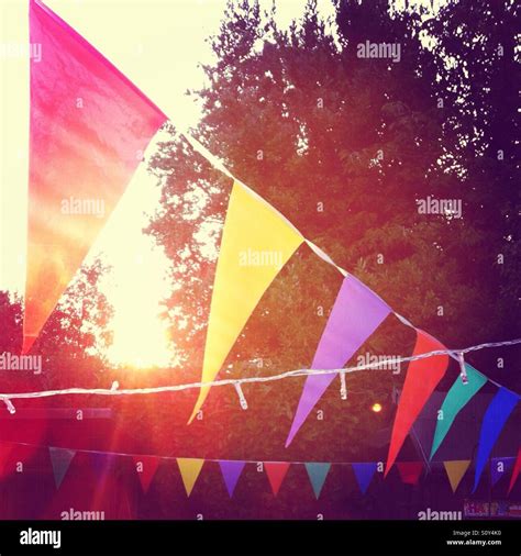 Colourful Bunting Hangs In The Summer Evening Sunshine At A Garden