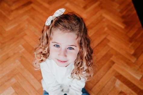 Premium Photo High Angle View Portrait Of Cute Girl Sitting On