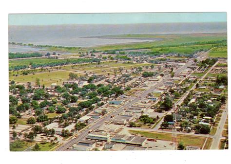 Chrome postcard. City of Clewiston looking east showing Clewiston Inn ...