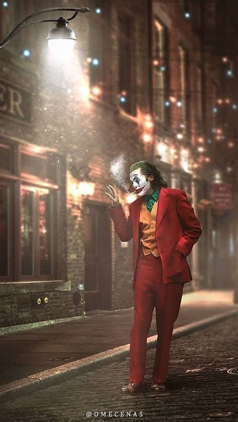 A Man Dressed As The Joker Standing On A Street